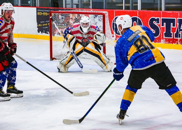 A Sweden attacker fires toward the net as the goaltender braces