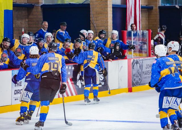 Players gather at the bench as teammates change on the fly