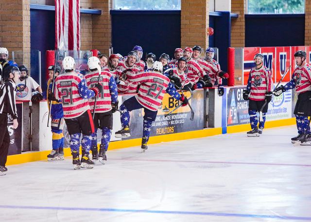 Players line up along the boards for the post-game handshake