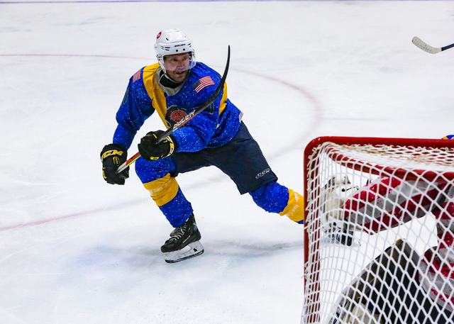 A Sweden player wheels behind the net with the puck