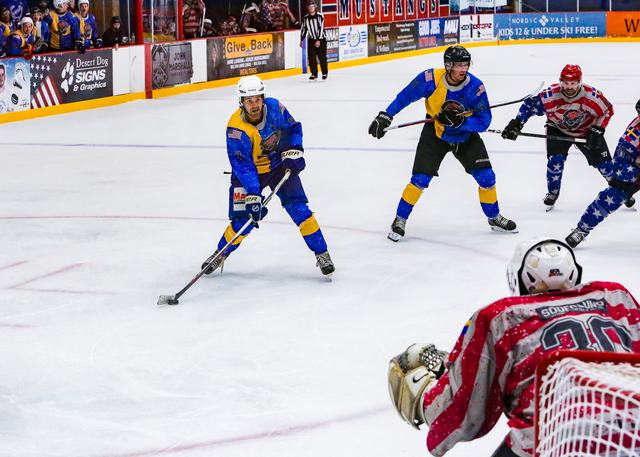 A Sweden attacker walks in on a sprawling goaltender