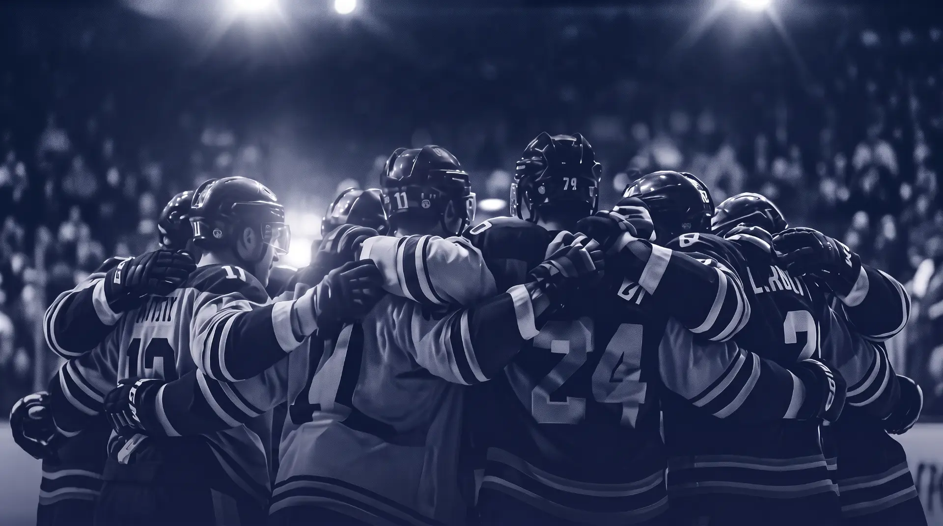 Hockey players in a team huddle under arena lights
