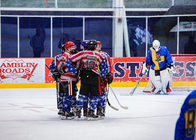 Teammates gather in a tight circle on the ice after the final whistle