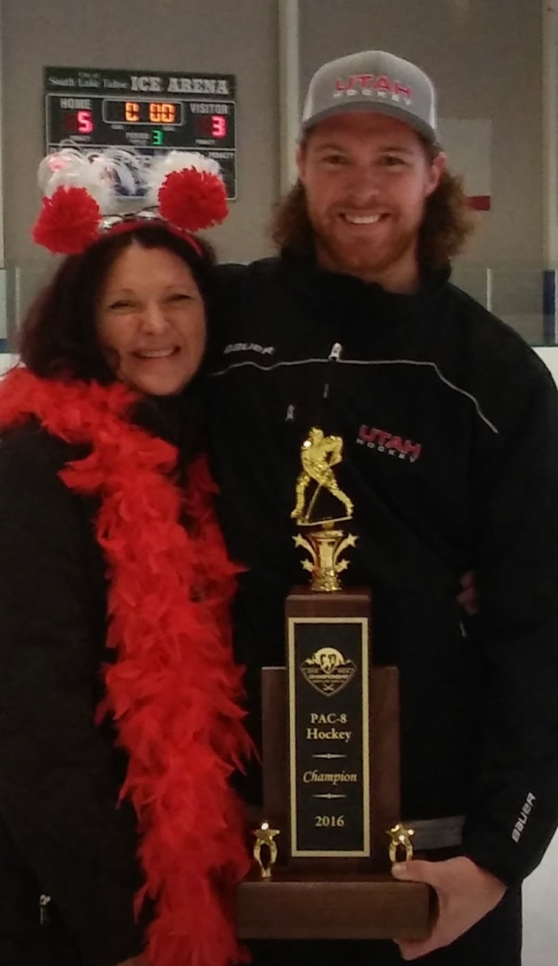 JoAnn and Nils with the PAC-8 Hockey Champion trophy