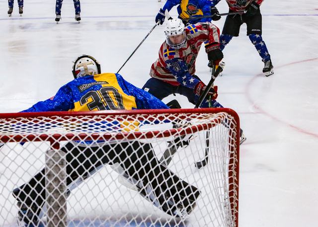 Traffic in front of the net as the goaltender makes a save