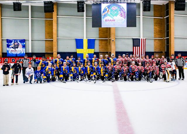 The full Sweden and USA rosters gathered on the ice for a team photo beneath the arena flags